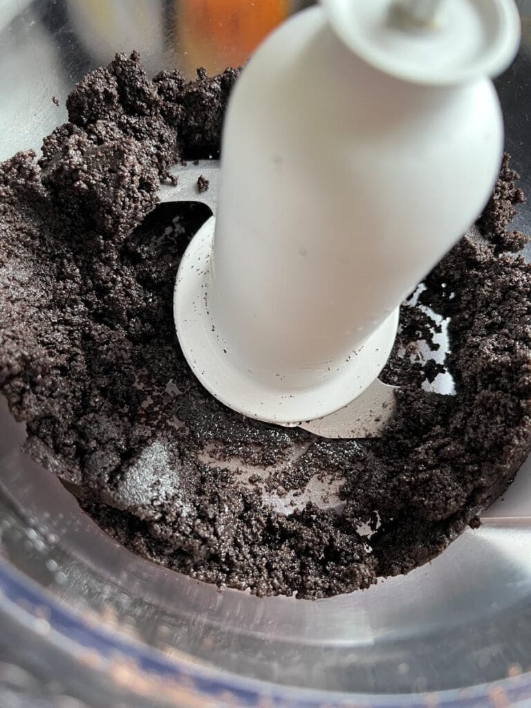 a food processor with crushed chocolate cookies.