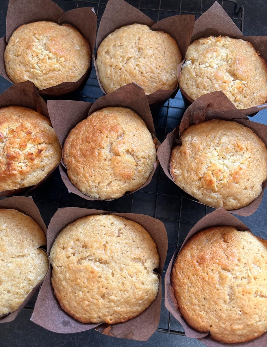 Nine freshly baked banana muffins in brown paper cases