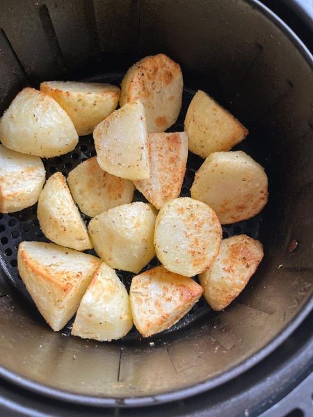 partially cooked roast potatoes in an air fryer.