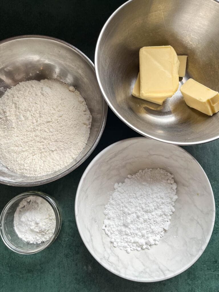 silver bowls of butter, flour, icing sugar and cornflour.