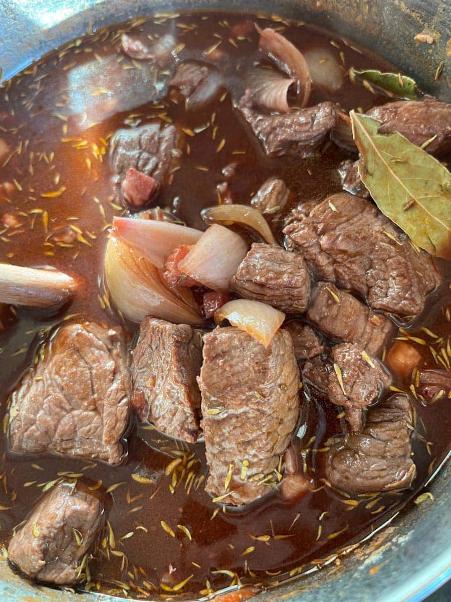 browned beef chunks, shallots, a bay leaf and dried thyme in red wine and beef stock.