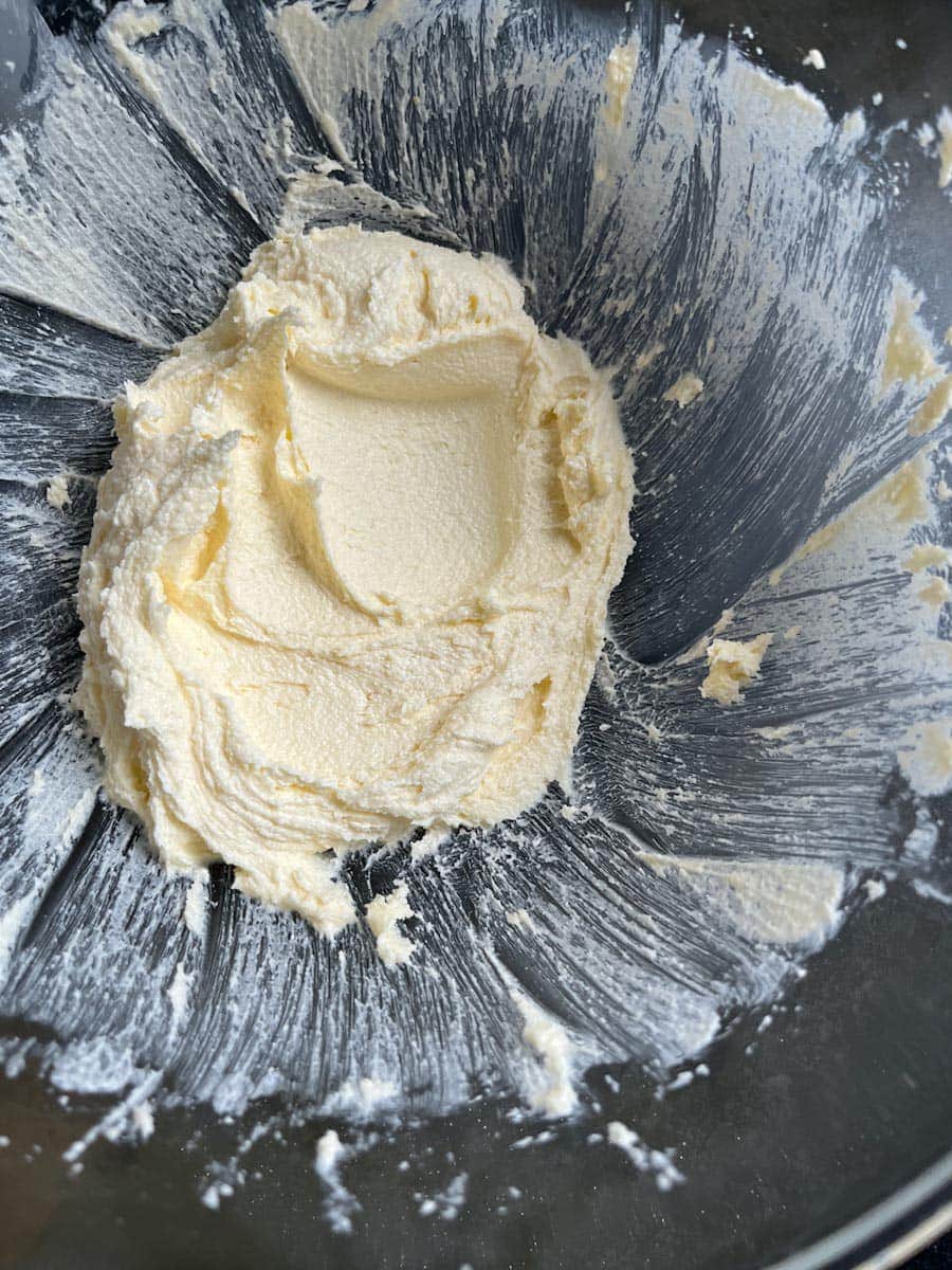 butter and sugar beaten together in a glass mixing bowl.