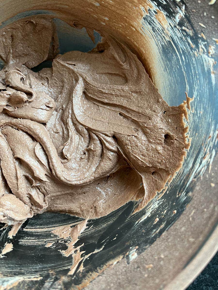 a glass mixing bowl of chocolate cake batter.