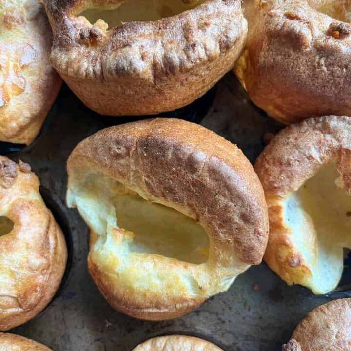 a metal baking tin of nine golden, well risen Yorkshire puddings.