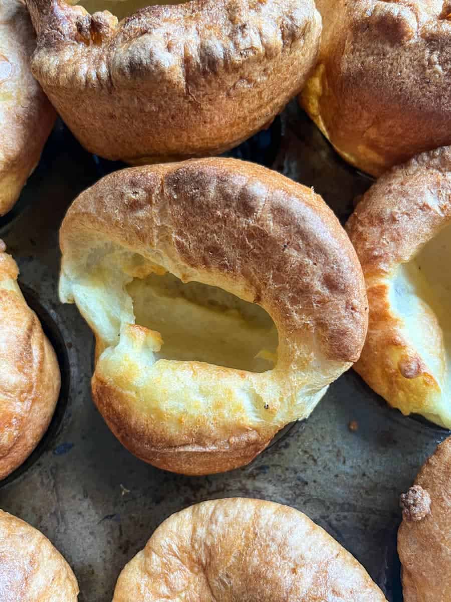 Yorkshire puddings in a metal baking tin.