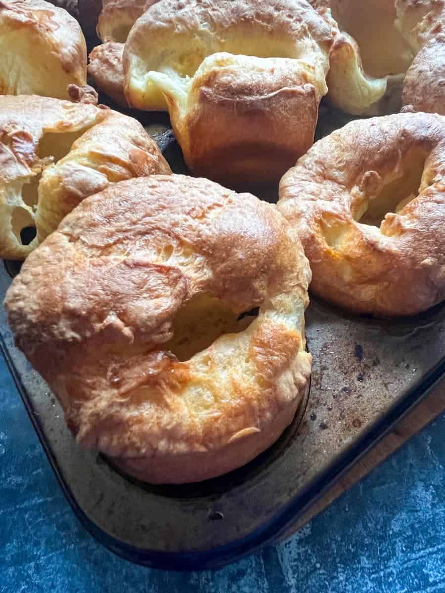 a metal muffin tin of freshly made golden Yorkshire puddings.