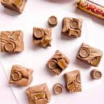 Nine pieces of Rolo Fudge on a piece of baking parchment and a packet of Rolos.