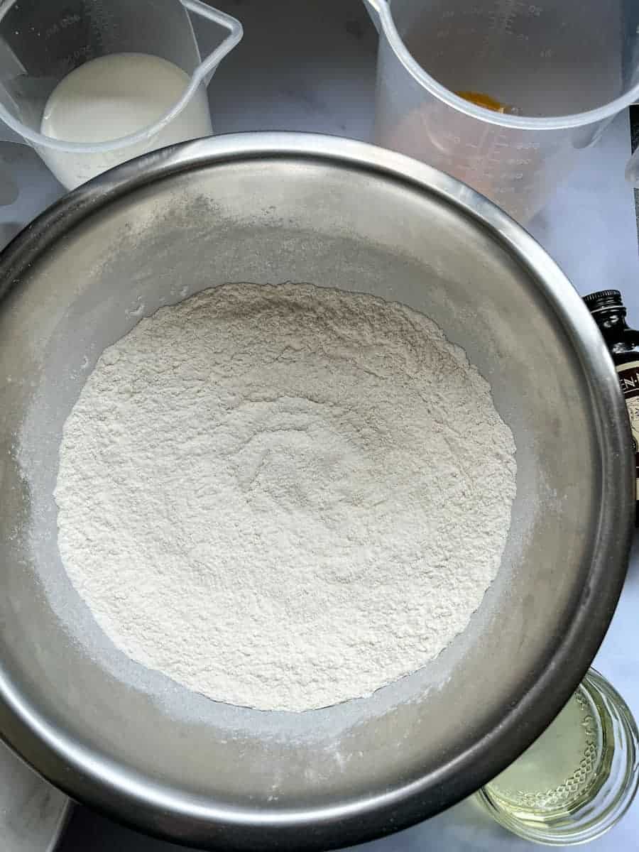 a large silver mixing bowl of flour.