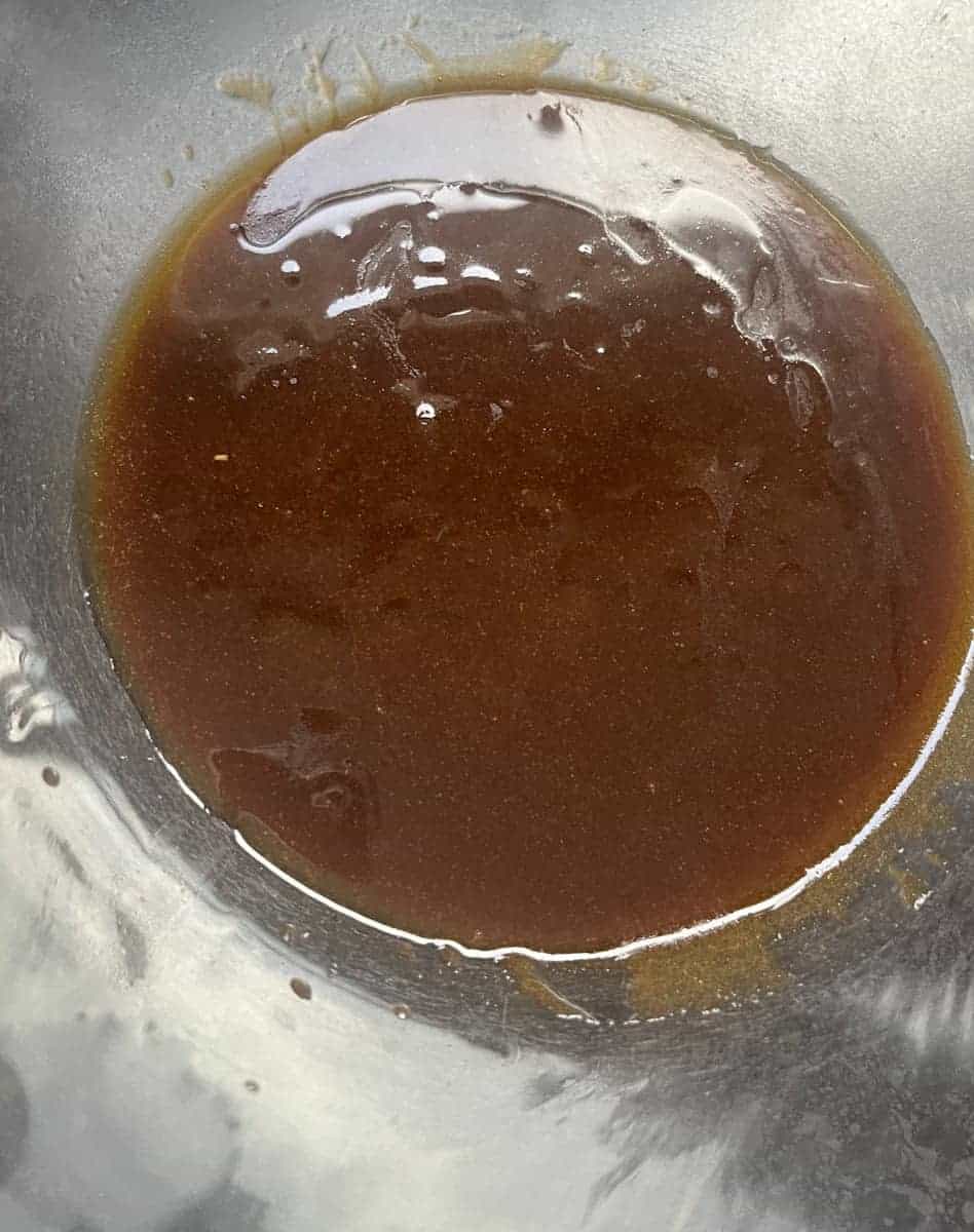melted butter and brown sugar in a glass mixing bowl.