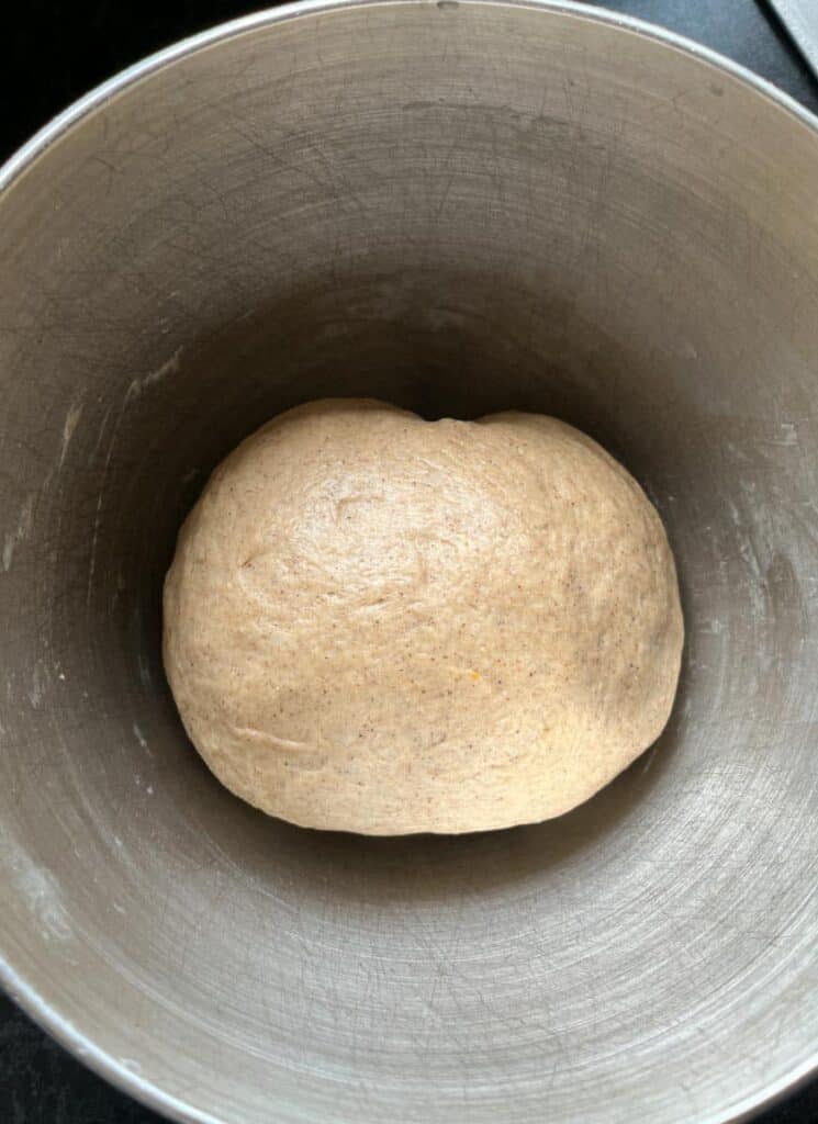 a silver bowl of bread dough.