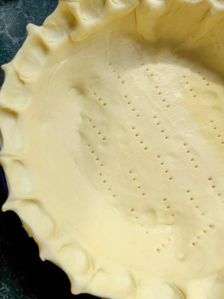 a round pie dish lined with shortcrust pastry.