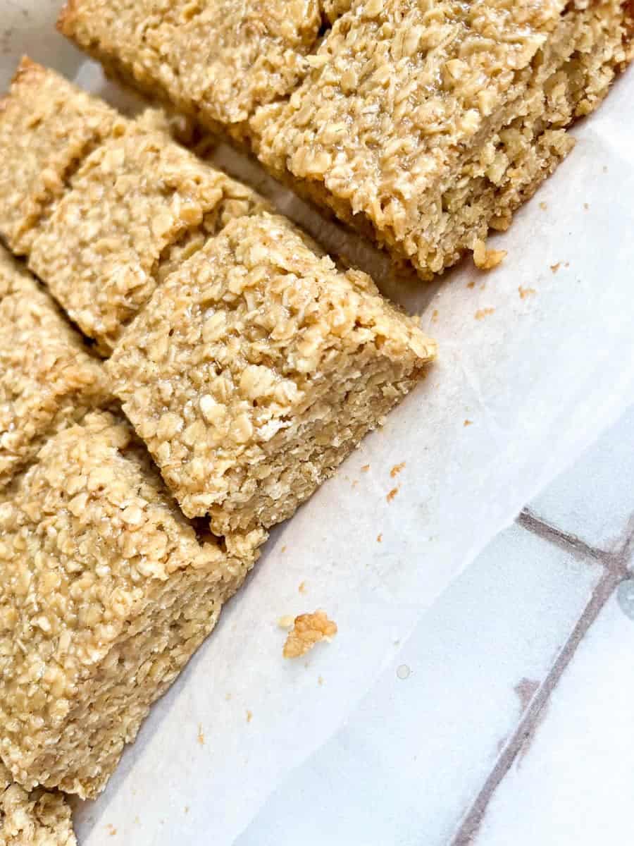 a batch of oat flapjack bars on a piece of baking parchment.