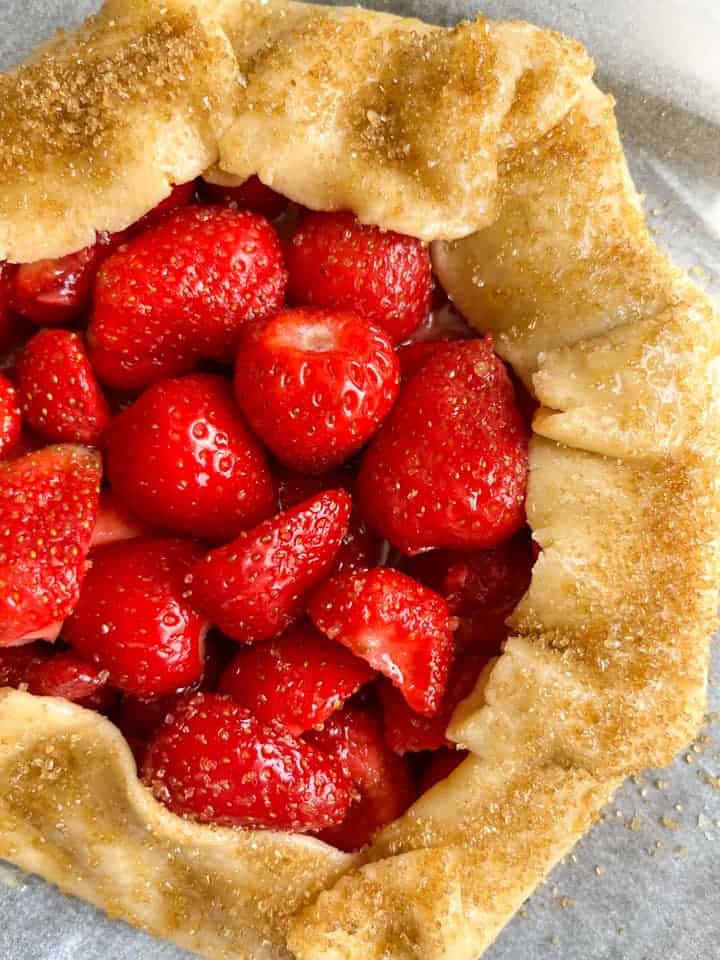 A galette filled with fresh strawberries and sprinkled with demerara sugar.