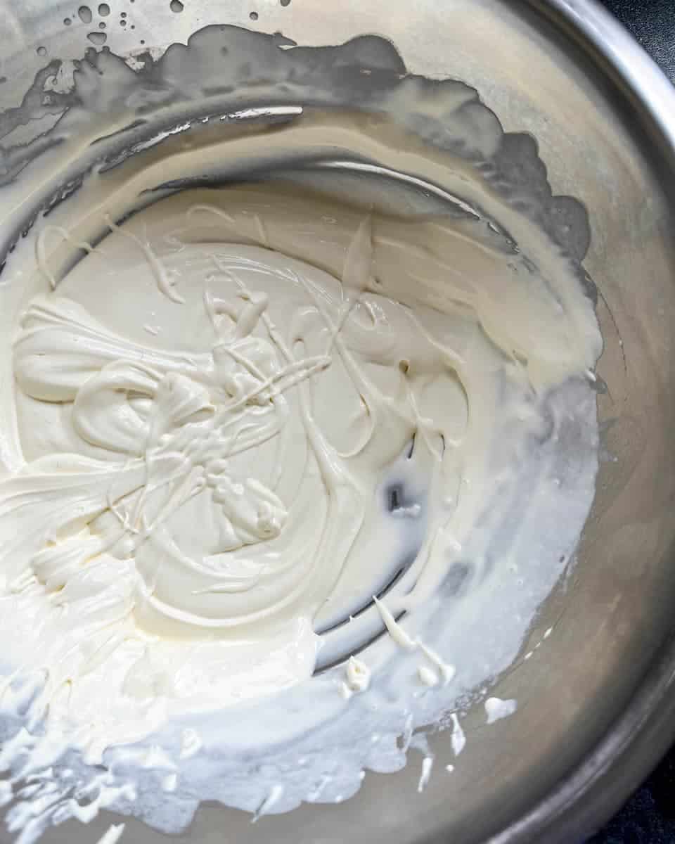 A silver bowl of whipped cream.