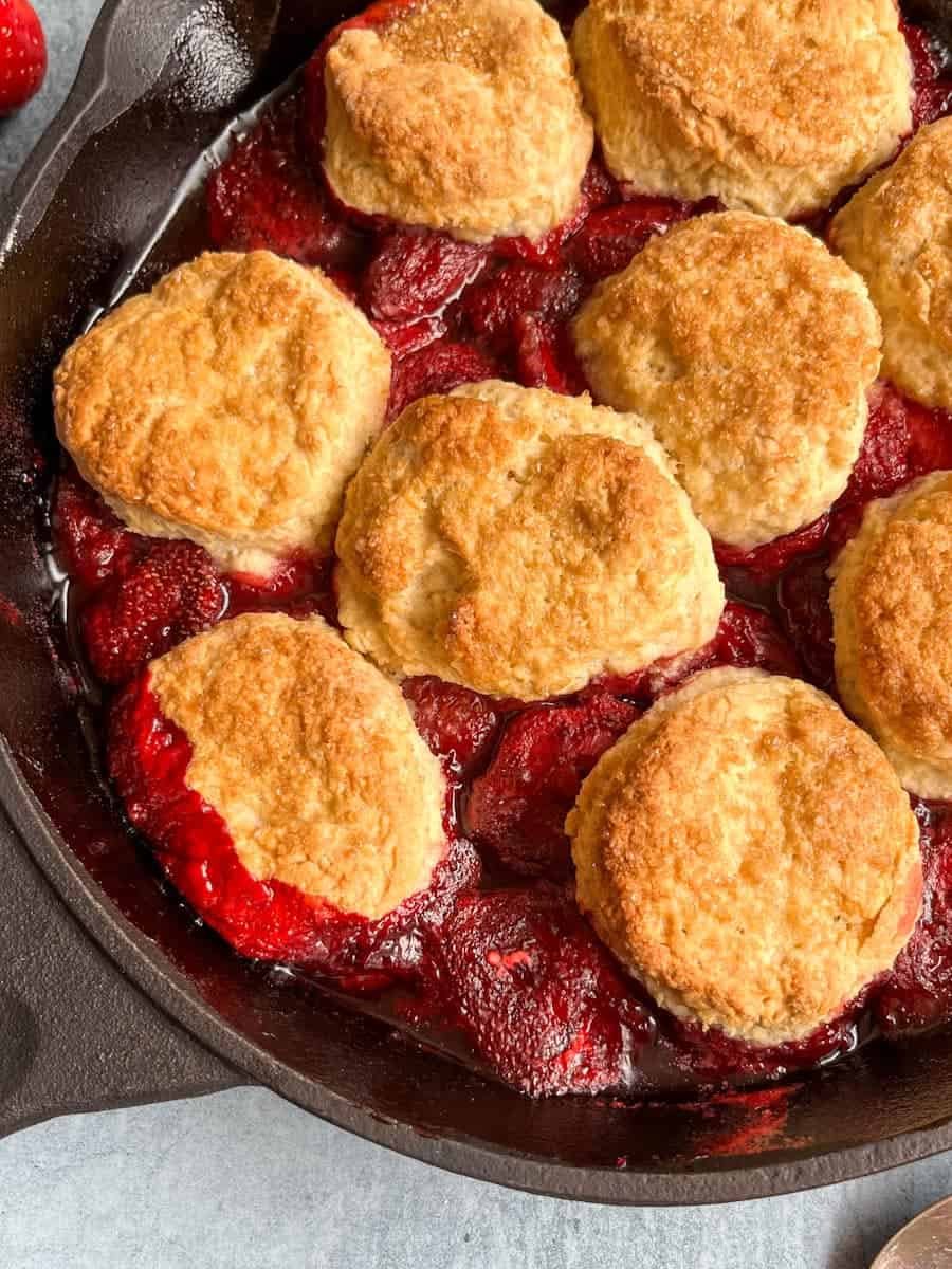 A strawberry cobbler in a black skillet.