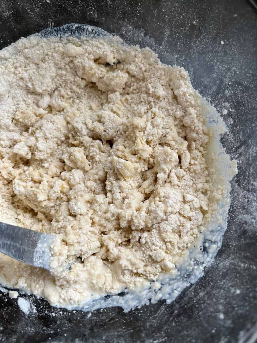 A large glass bowl of scone dough.