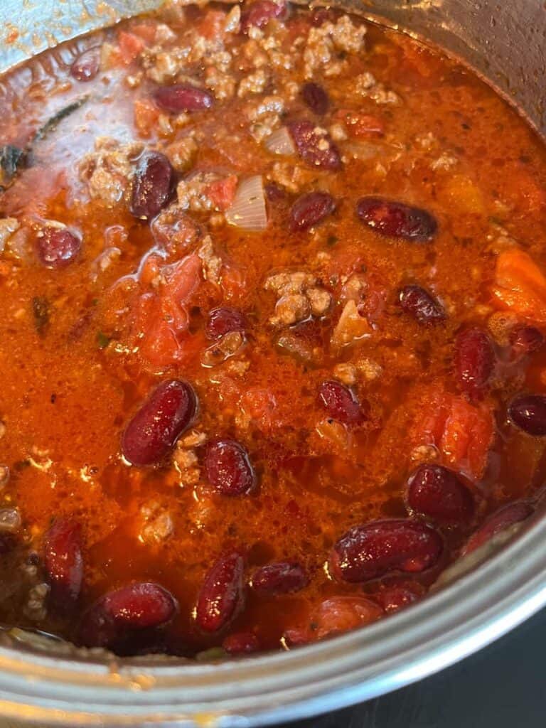 A saucepan of chill con carne with kidney beans.
