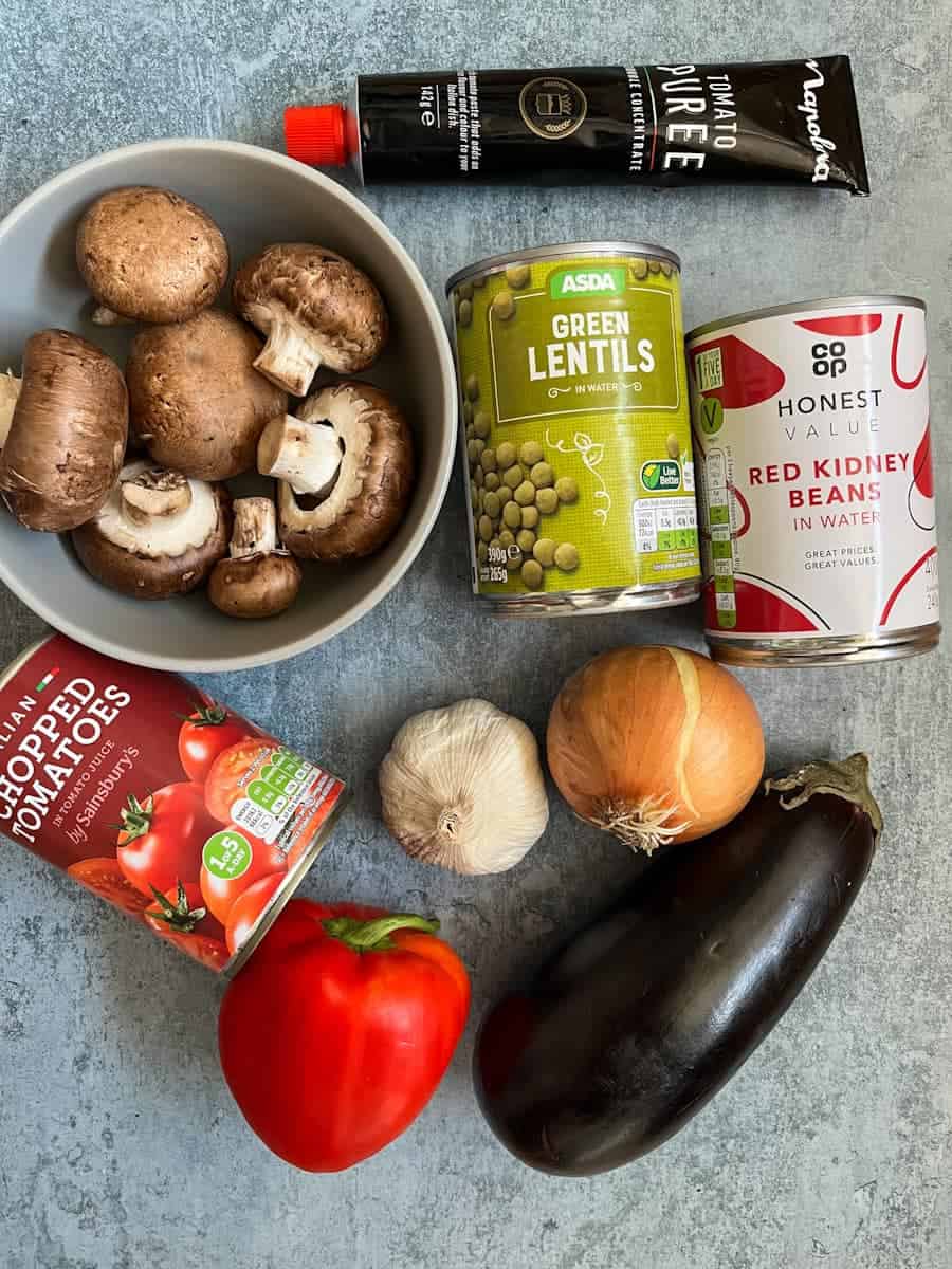 A selection of ingredients for making aubergine mushroom lentil chilli.