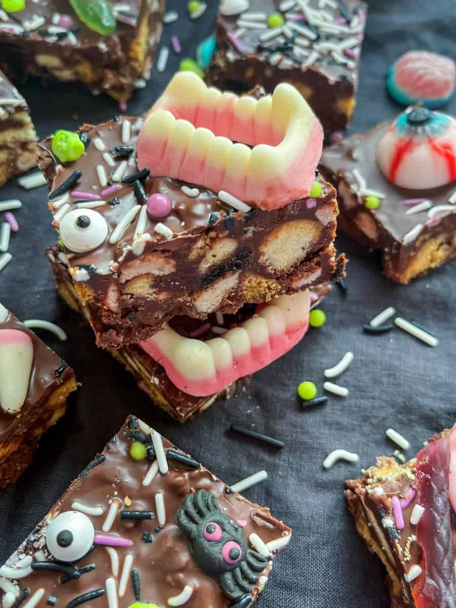 Squares of rocky road with Halloween candy teeth, eyes and Halloween sprinkles.