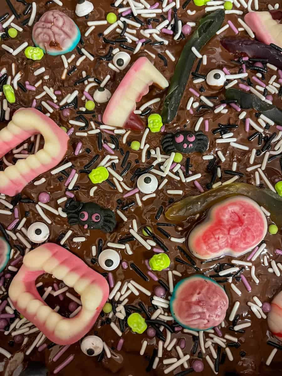 Halloween rocky road topped with Halloween sweets and sprinkles.