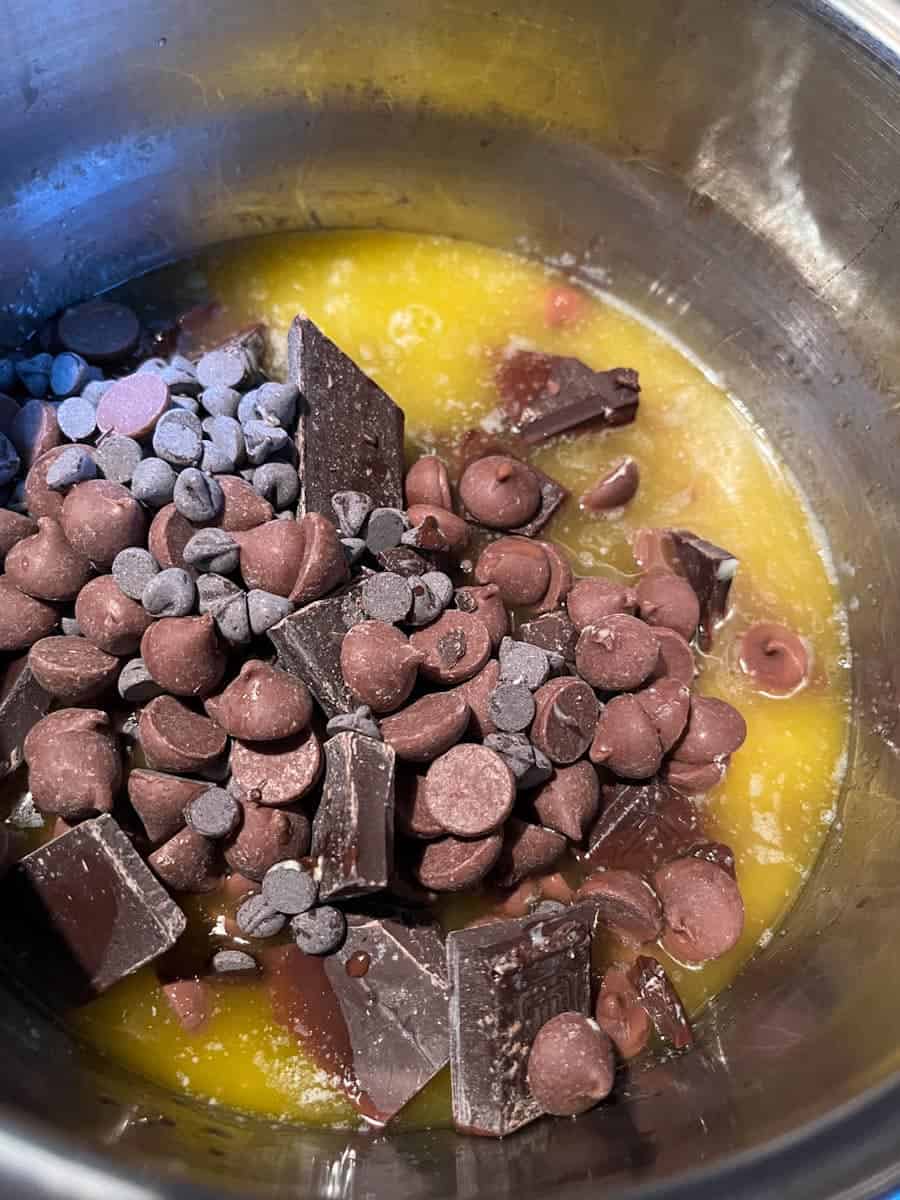 Butter and chocolate melting in a silver saucepan.