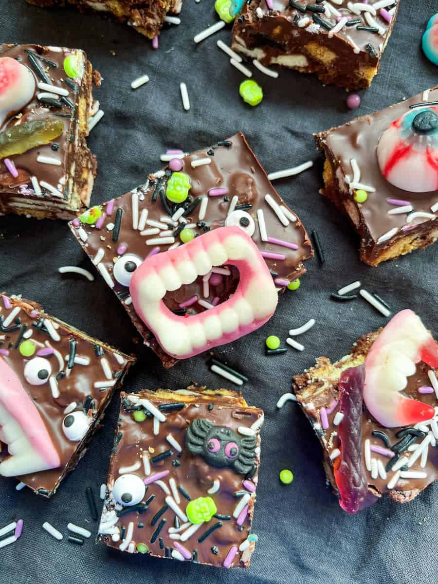 Halloween rocky road bars decorated with Halloween sweets and sprinkles.