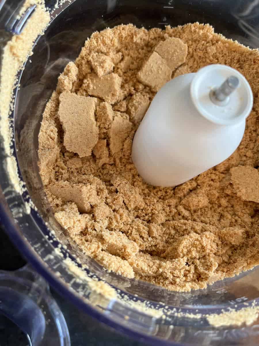 Crushed digestive biscuits inside a food processor.