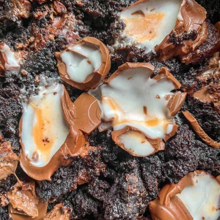 A chocolate sponge pudding with broken creme eggs.