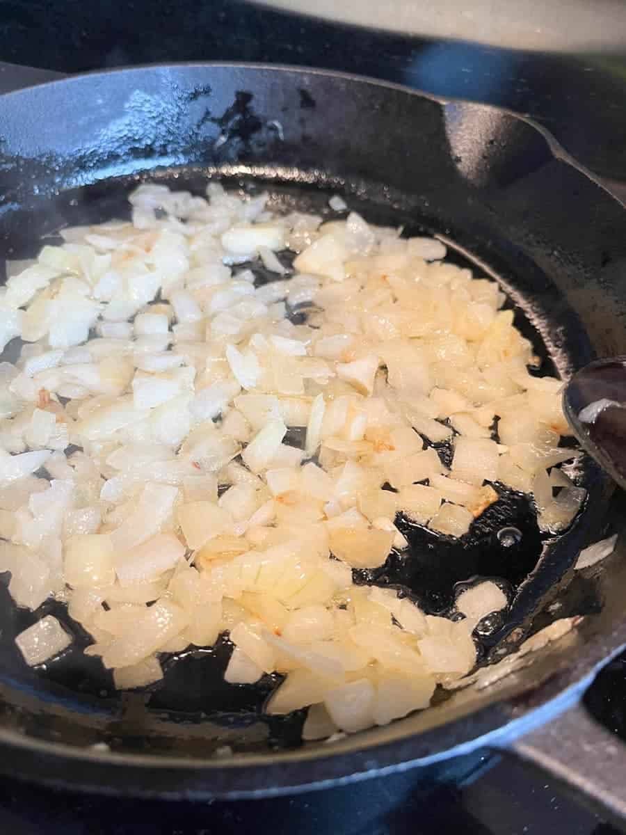 Chopped onions cooking in a saucepan.