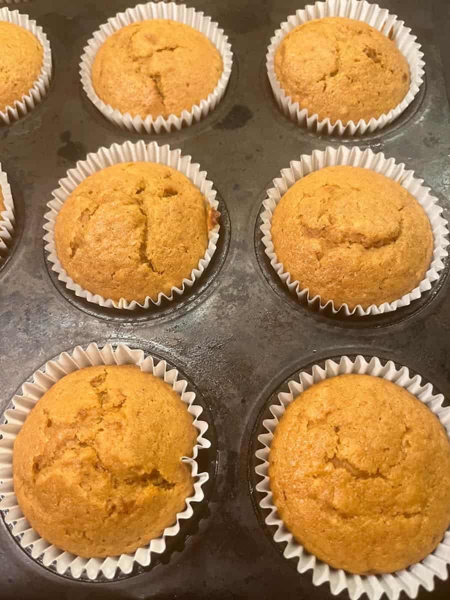 A cupcake tin filled with pumpkin cupcakes.