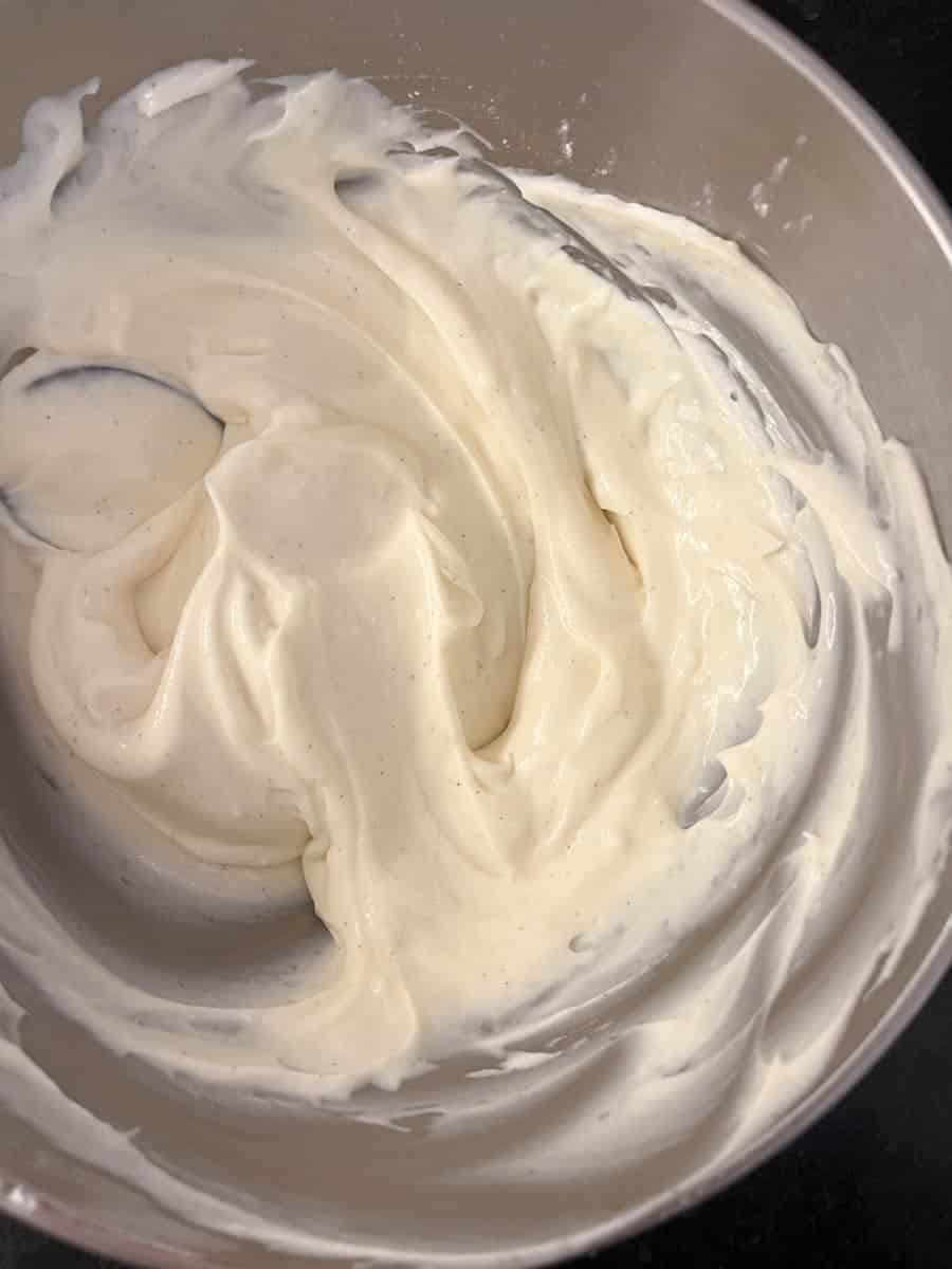 A silver bowl of whipped cream cheese.