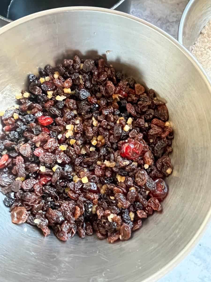 A silver bowl of dried fruit, such as cranberries, raisins, sultanas and mixed peel.
