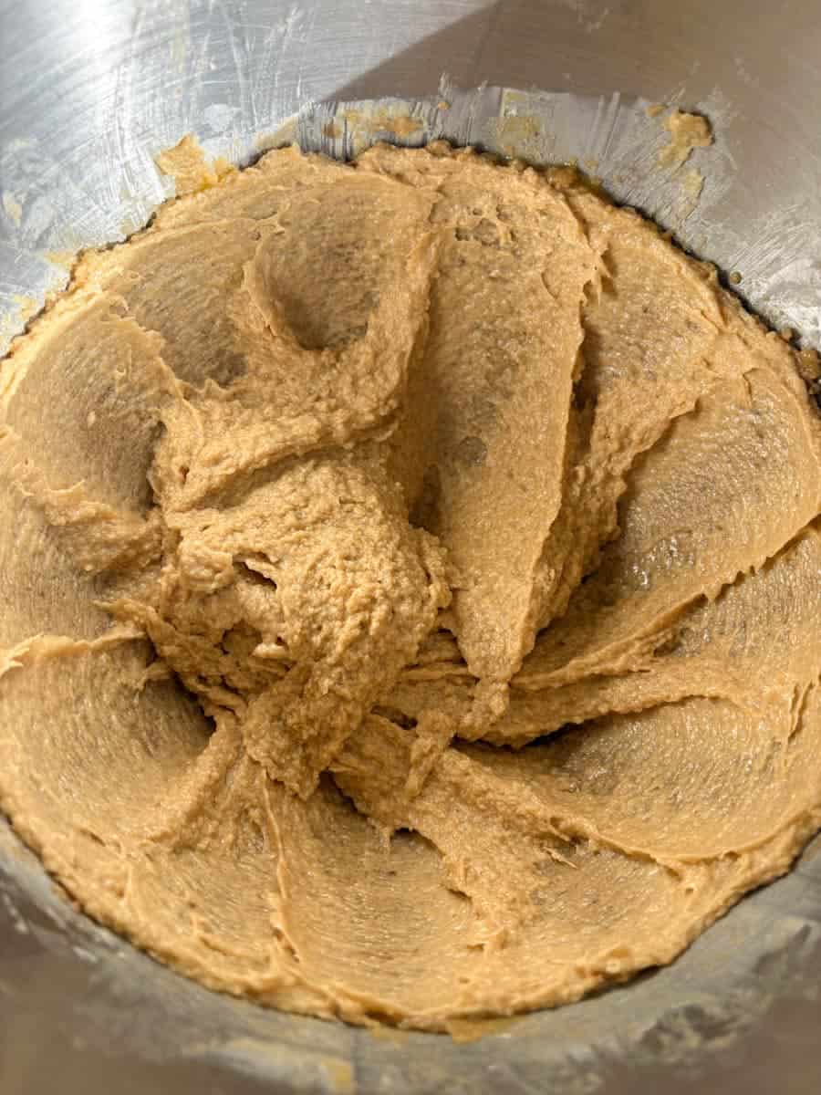 A silver bowl of creamed butter and brown sugar.