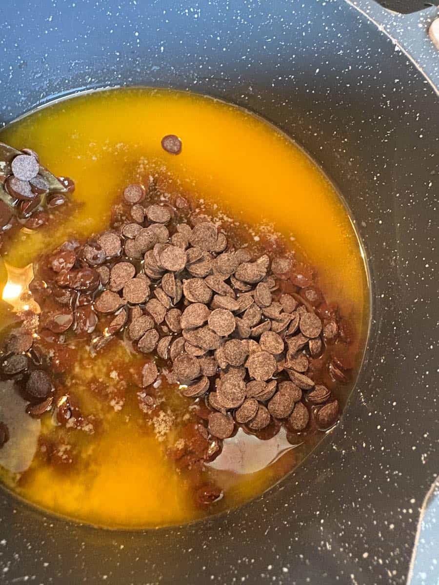 A saucepan of melted butter and chocolate chips.