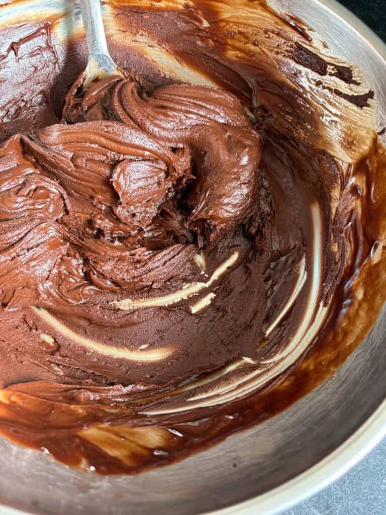 A silver bowl of melted chocolate.