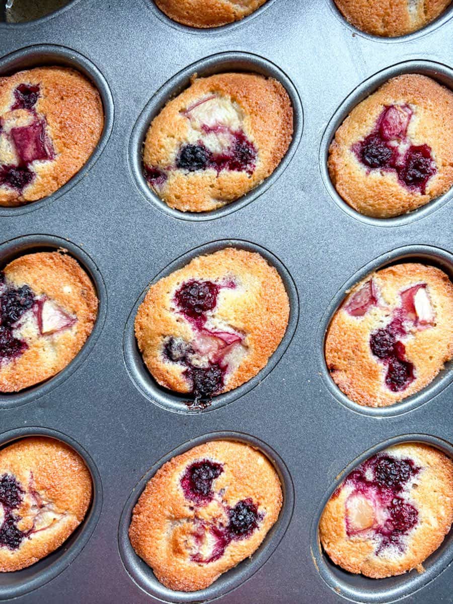A freshly baked pan of peach and blackberry Friands.
