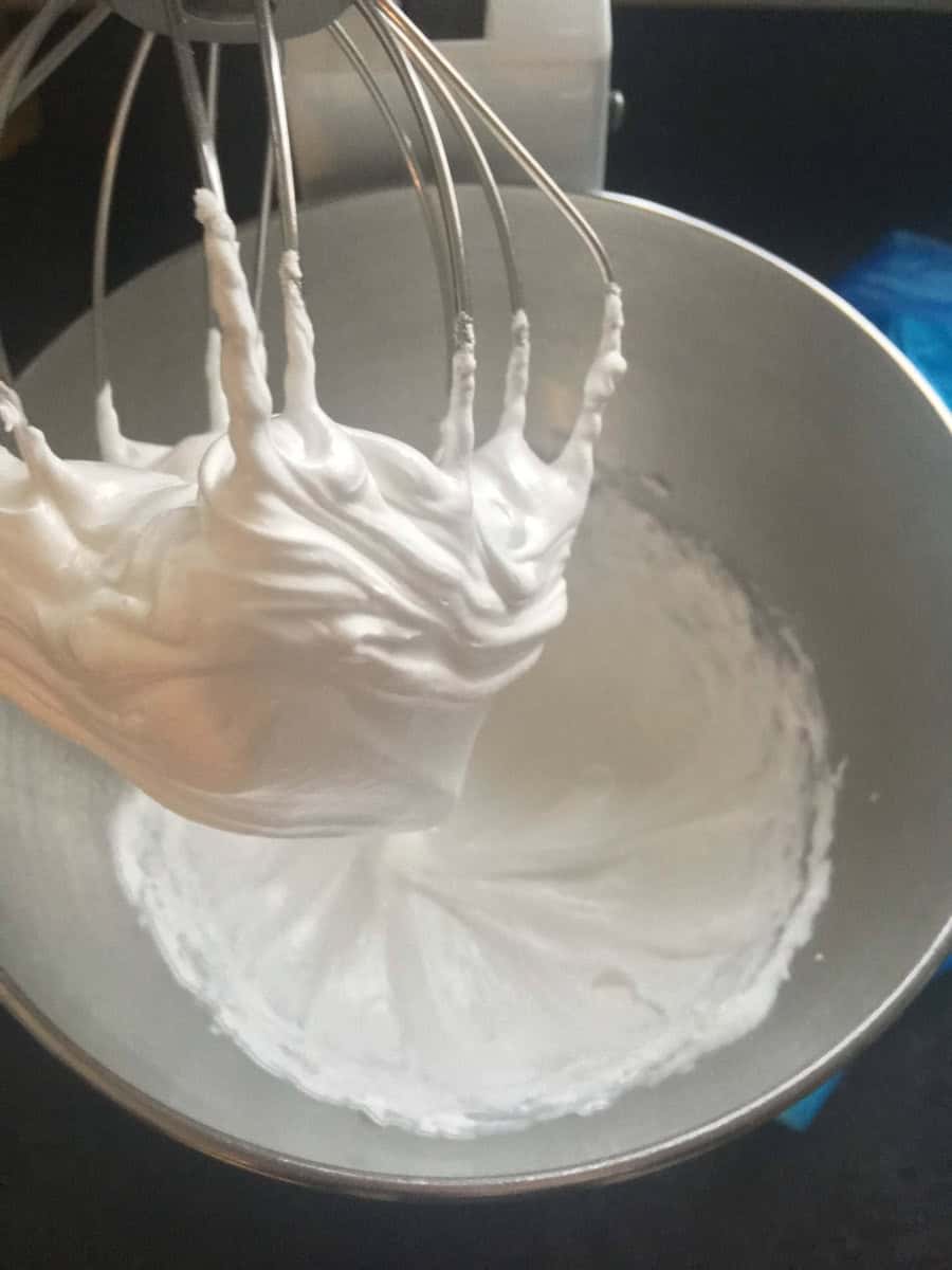 A silver bowl of stiffly whisked meringue.